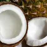 Divided coconuts with pineapple on background