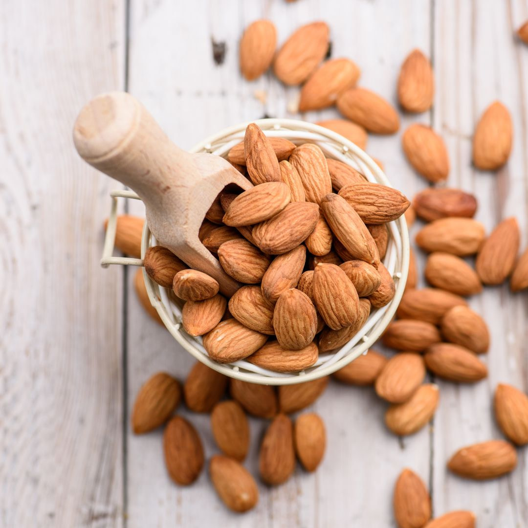 almonds in a basket on a wooden table