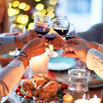 a group of people toasting champagne glasses at a christmas party