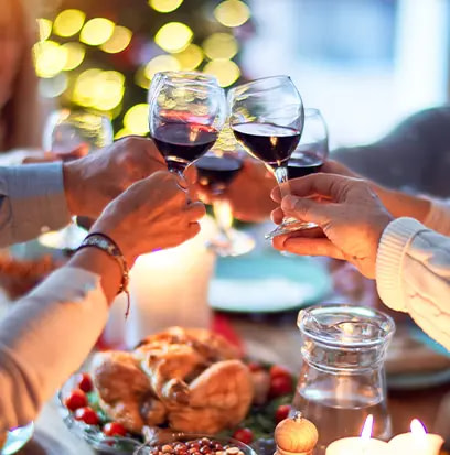 a group of people toasting champagne glasses at a christmas party