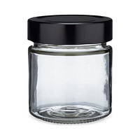 a glass jar with a black lid on a white background