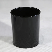 A cup sitting on top of a white surface
