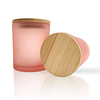 pink glass jar with wooden lid on white background