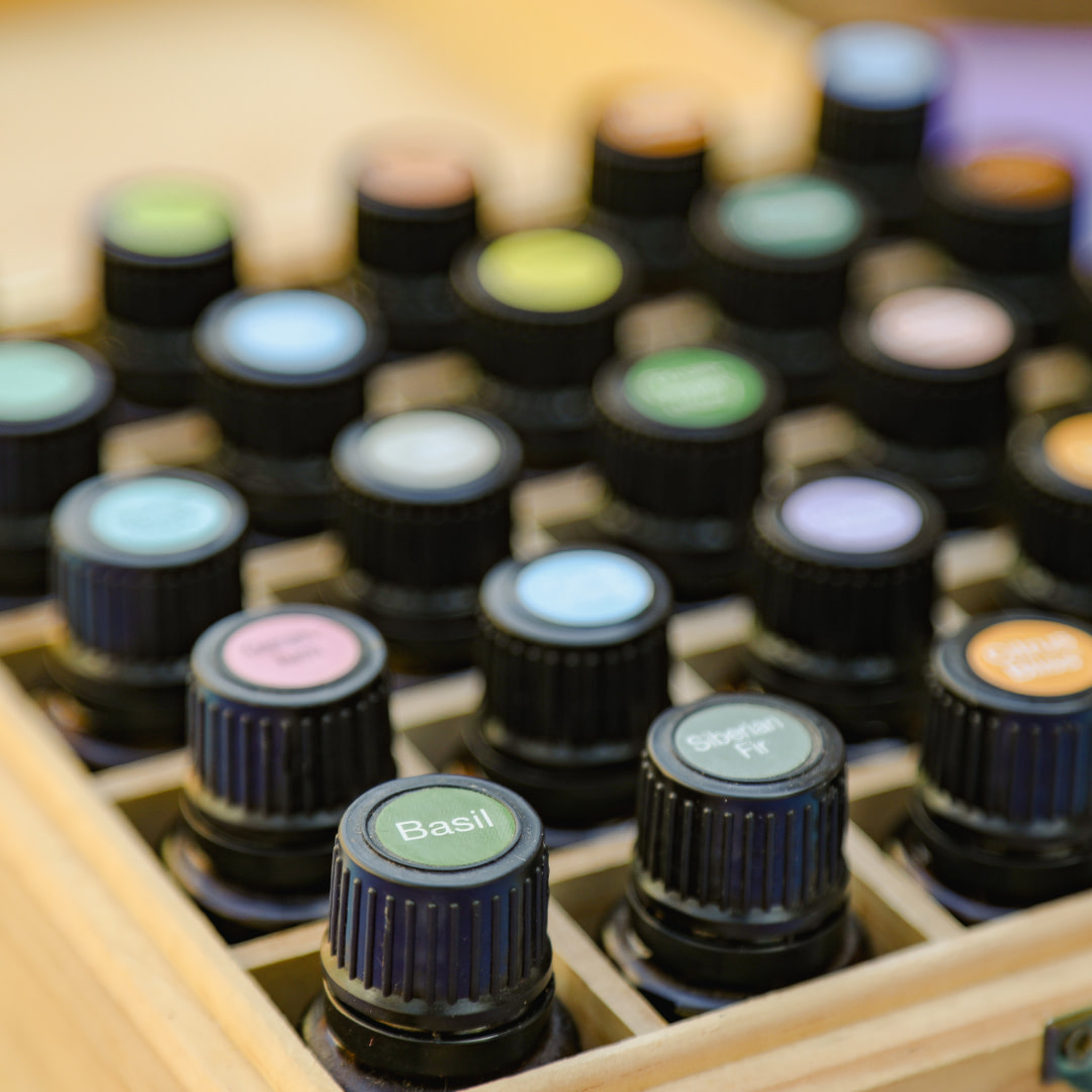 an assortment of essential oils in a wooden box