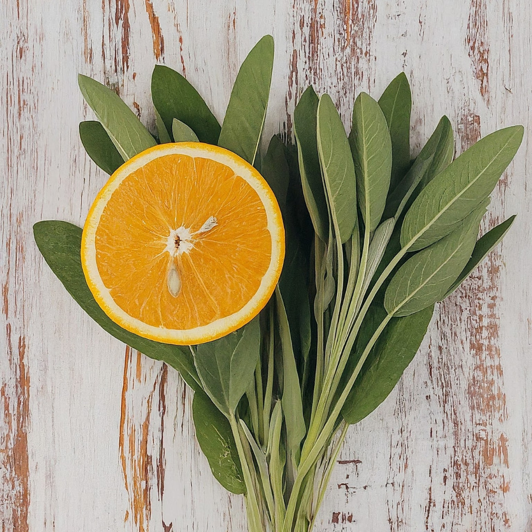 sage leaves and an orange on a wooden surface