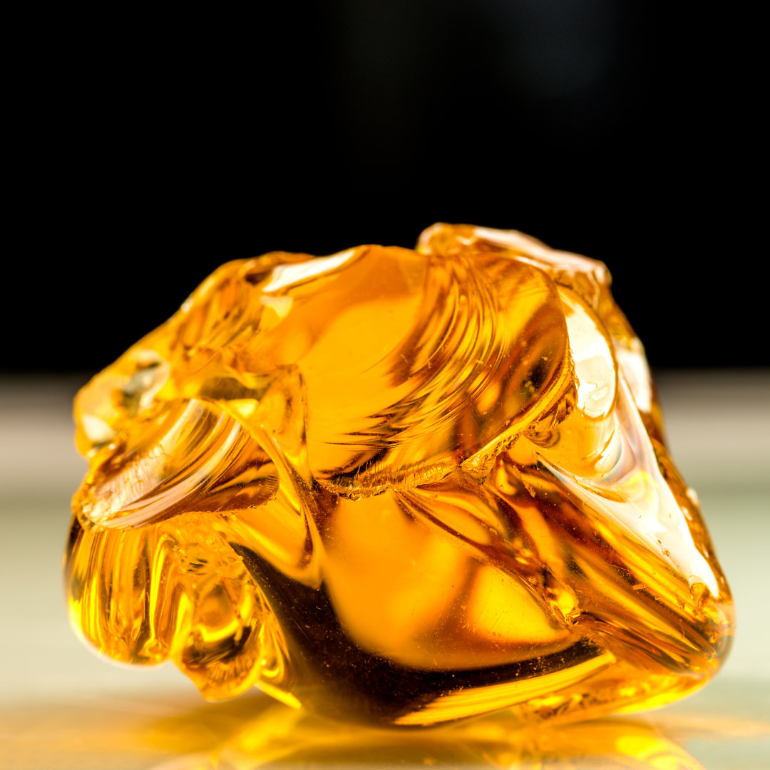 a yellow glass object sitting on top of a table