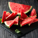 slices of watermelon on a black slate