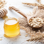 honey, oats and milk on a wooden table