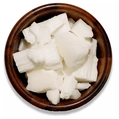 coconut flakes wax in a wooden bowl with a white background