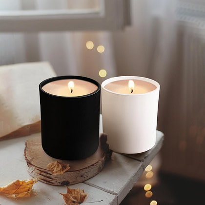 two candles sit next to each other on a table