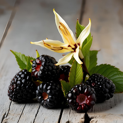 a bunch of blackberries and a flower on a wooden table