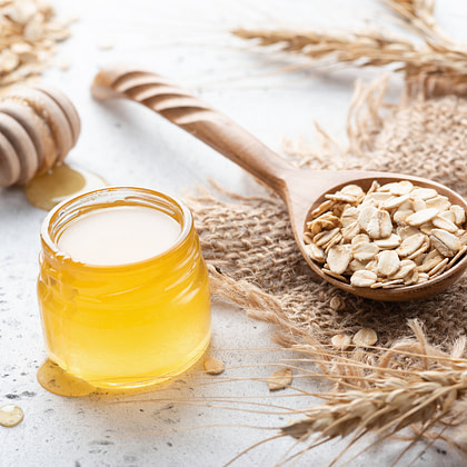 honey, oats and milk on a wooden table