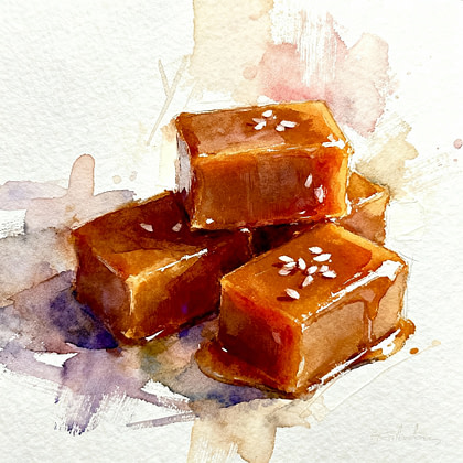 3 pieces of brown cubes of caramel, one on top of other