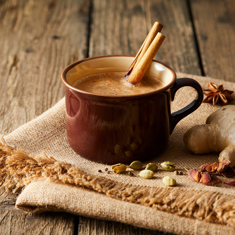 cinnamon and ginger tea in a mug on a wooden table