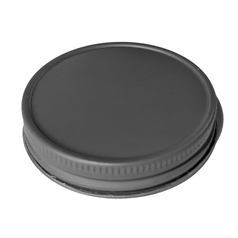 a dark gray lid on a white surface
