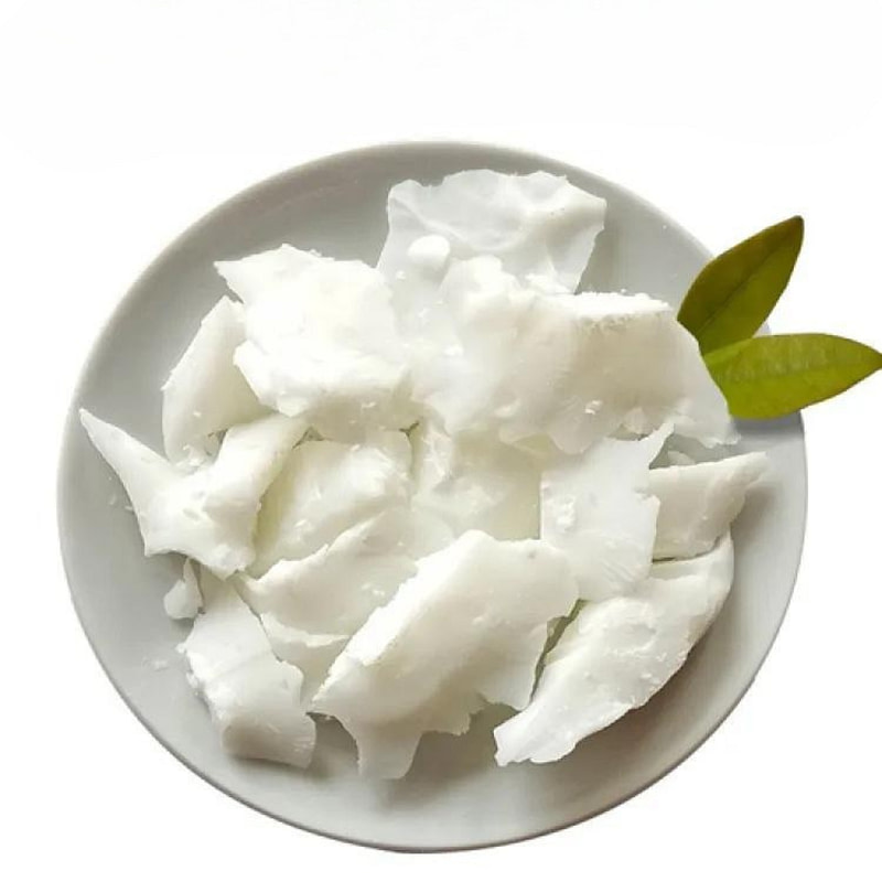 coconut flakes in a white plate on a white background