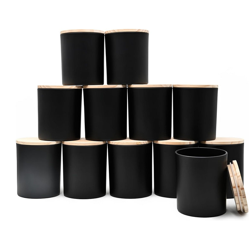 a stack of black jars with wooden lids