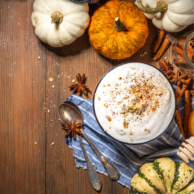 pumpkin latte with spices and spices on a wooden table