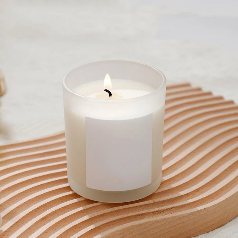 a candle sitting on top of a wooden tray