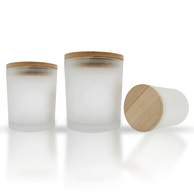 three glass jars with wooden lids on a white surface