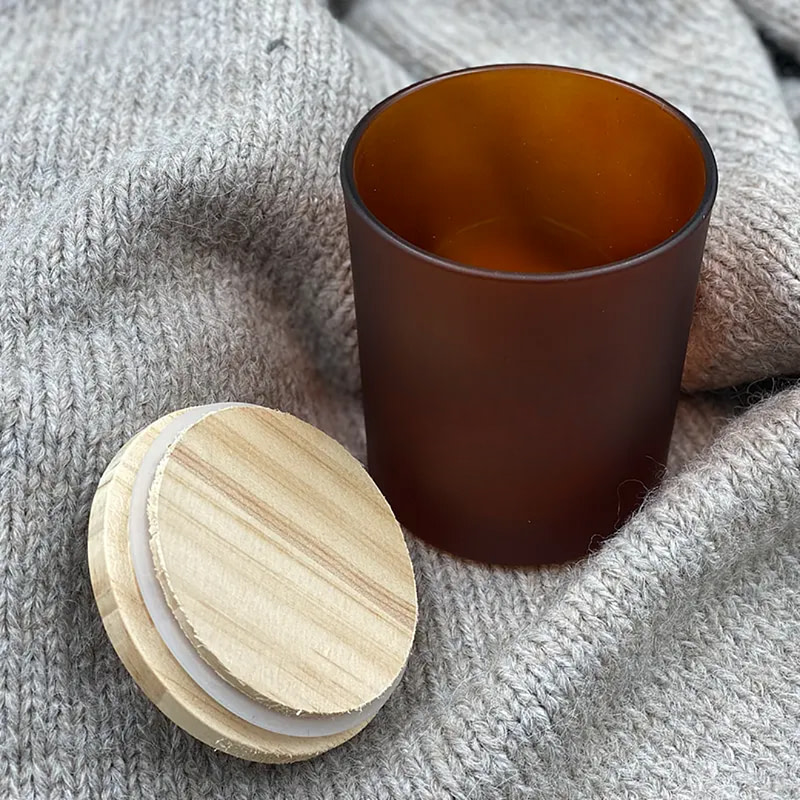 Glass jars beside wooden lid on fabric background