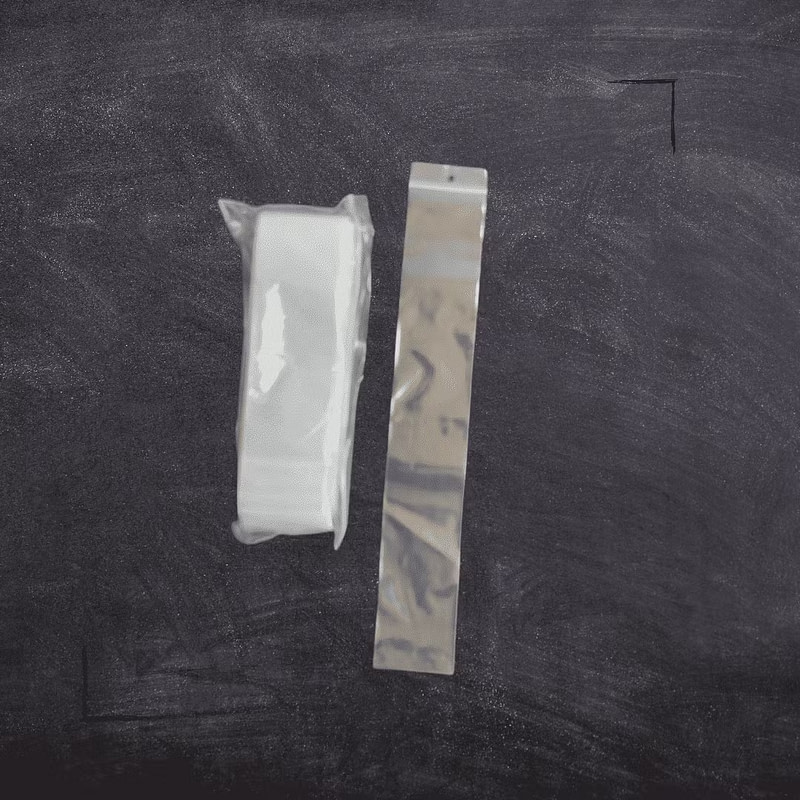 a pair of zip bags on top of a blackboard