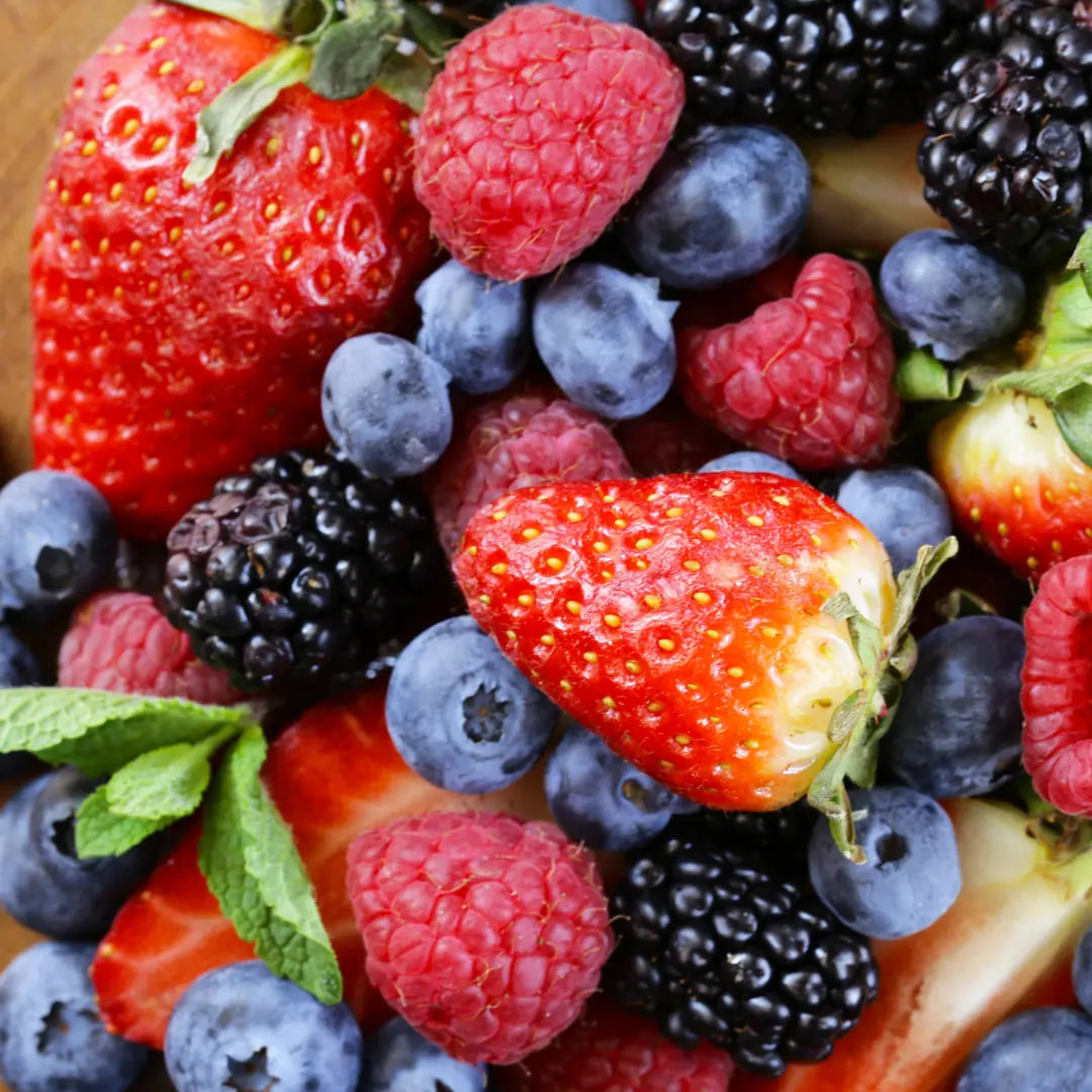 a bowl full of raspberries, blueberries and blackberries